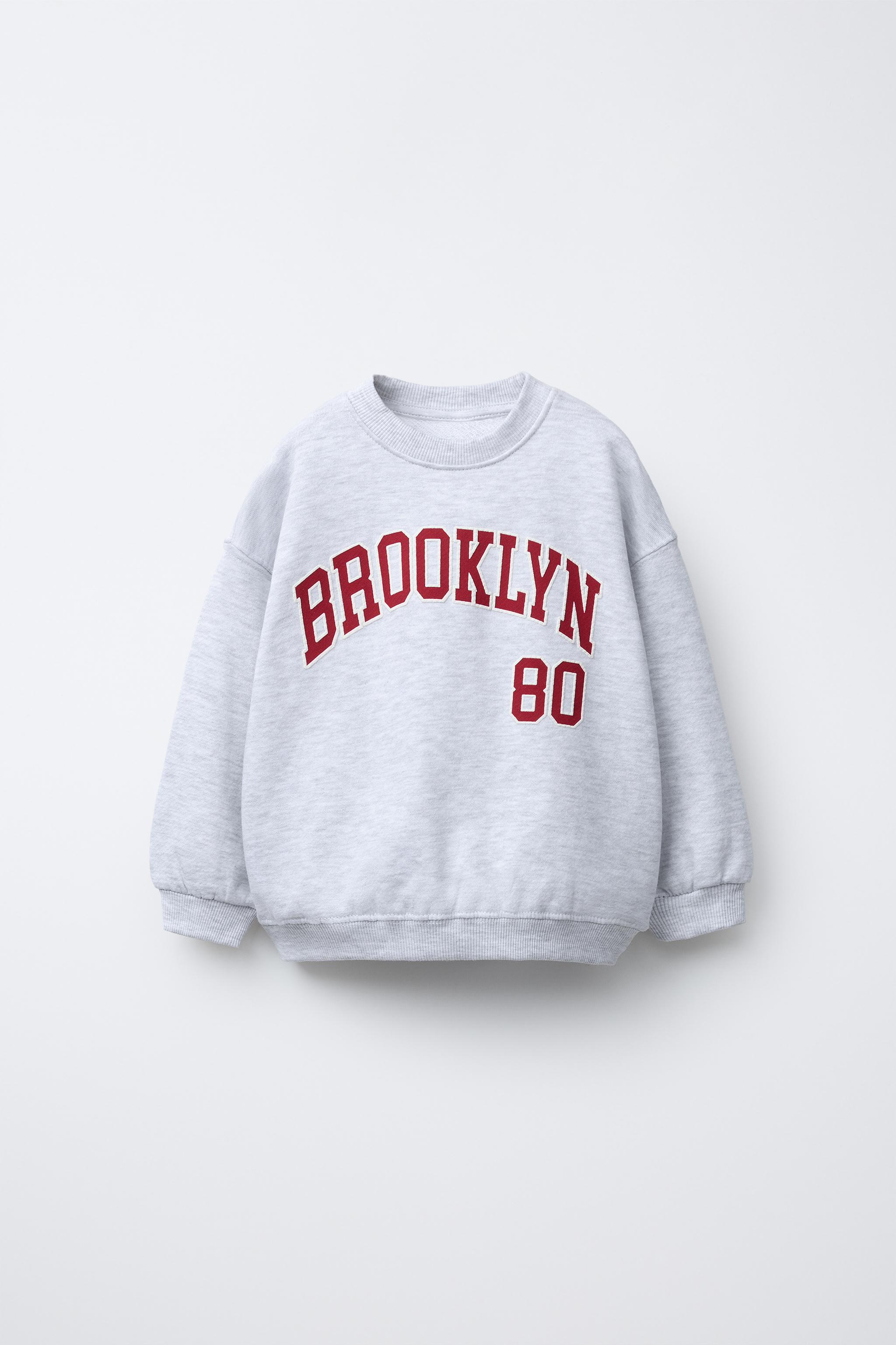 RAISED TEXT SWEATSHIRT